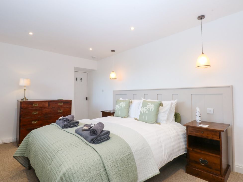 A bedroom with a double bed and bedside table at Yr Hen Felin in Dyffryn Ardudwy
