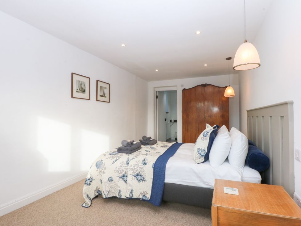 A bedroom with a bed and nightstand at Yr Hen Felin in Dyffryn Ardudwy