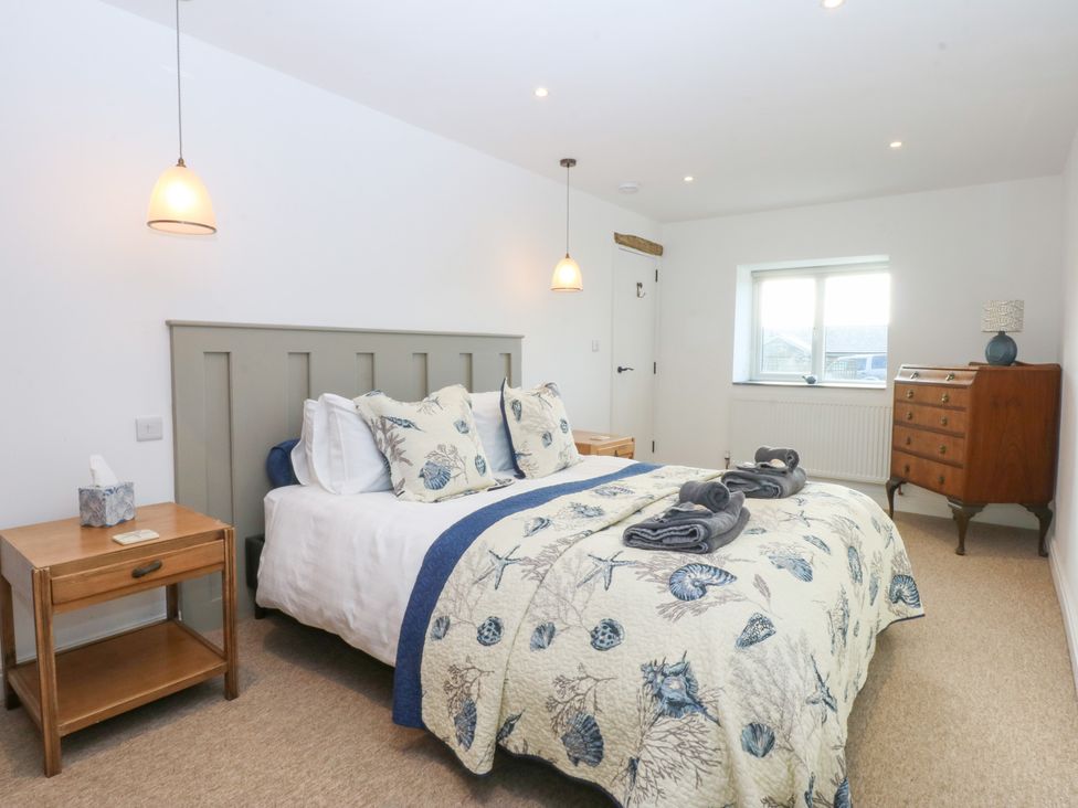 A bedroom with a bed and bedside table at Yr Hen Felin in Dyffryn Ardudwy