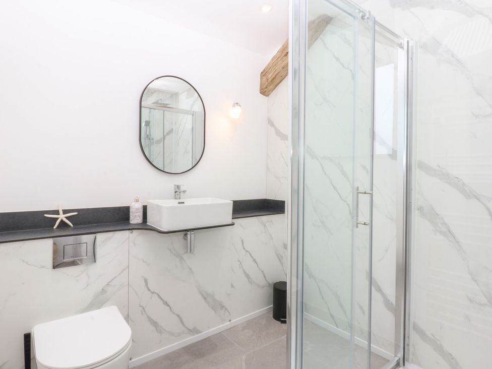 A bathroom with a sink and shower at Yr Hen Felin Dyffryn Ardudwy