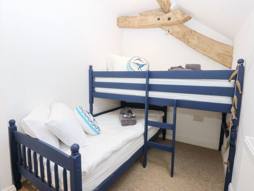 A bedroom with a blue bunk bed at Yr Hen Felin in Dyffryn Ardudwy