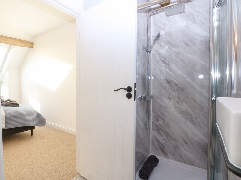 A bathroom with a shower and towel at Yr Hen Felin Dyffryn Ardudwy