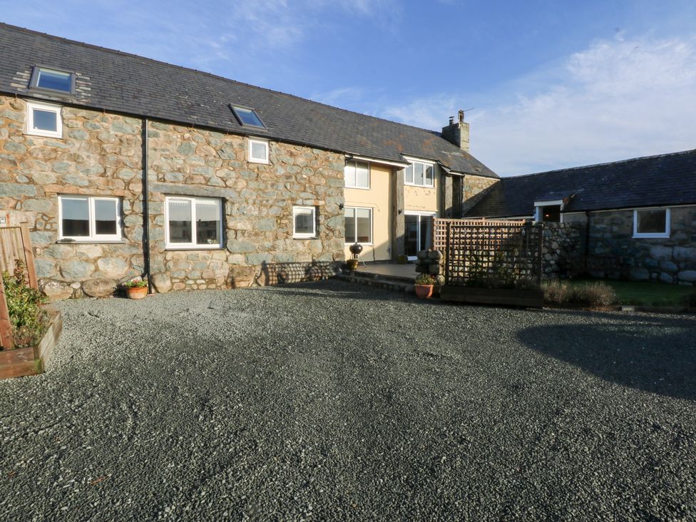 An outdoor area with a stone building and gravel at Yr Hen Felin in Dyffryn Ardudwy