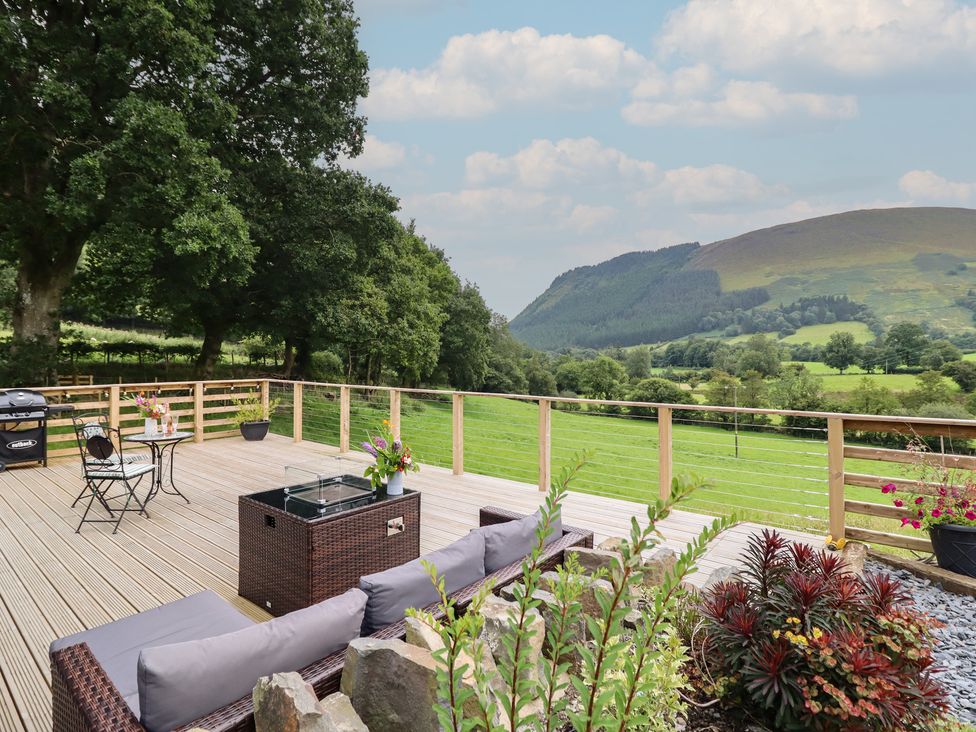 An outdoor space with seating and views of mountains at Caban Tirion in Dinas Mawddwy near Dolgellau