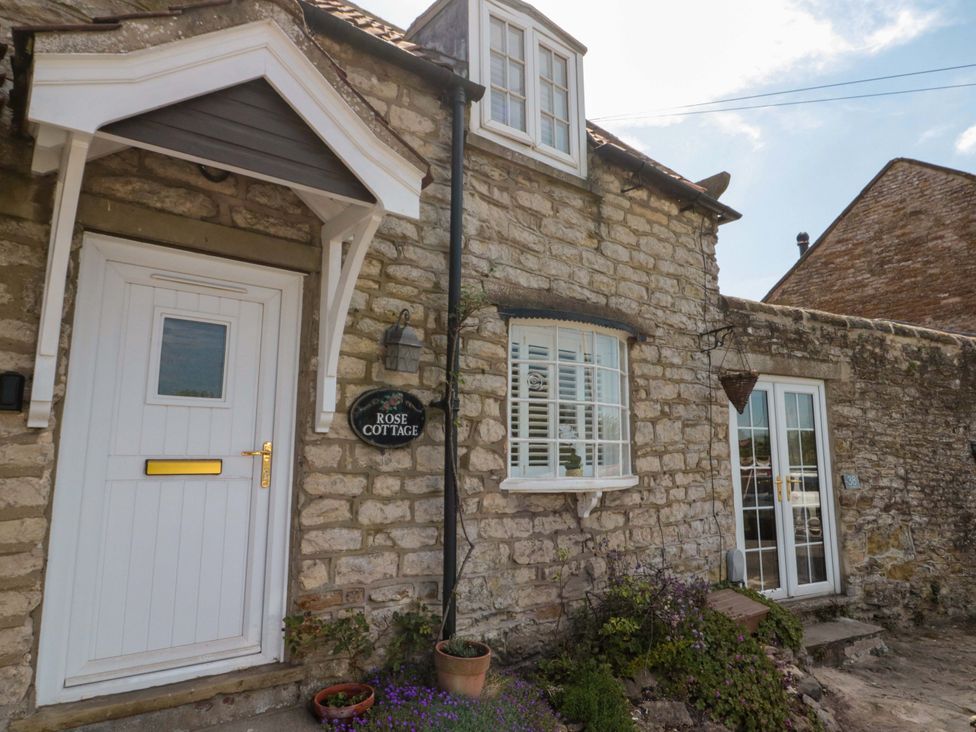 The entrance of Rose Cottage with a door and window in East Ayton