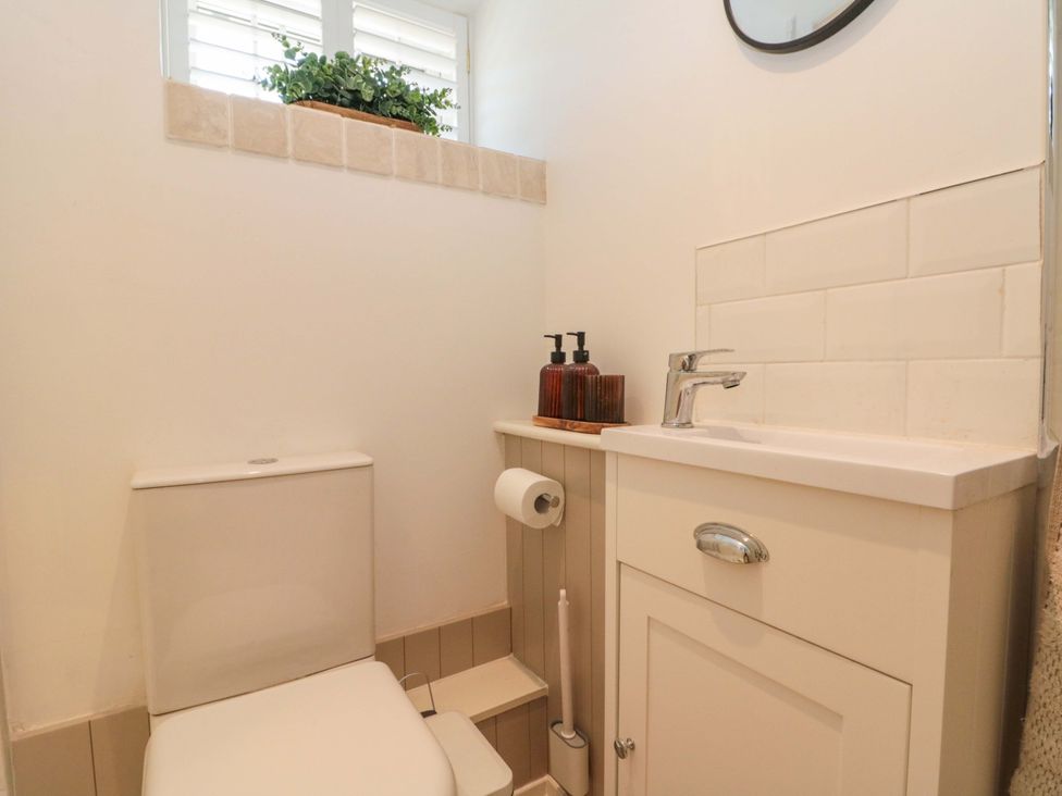 A bathroom with a toilet and sink at Rose Cottage in East Ayton