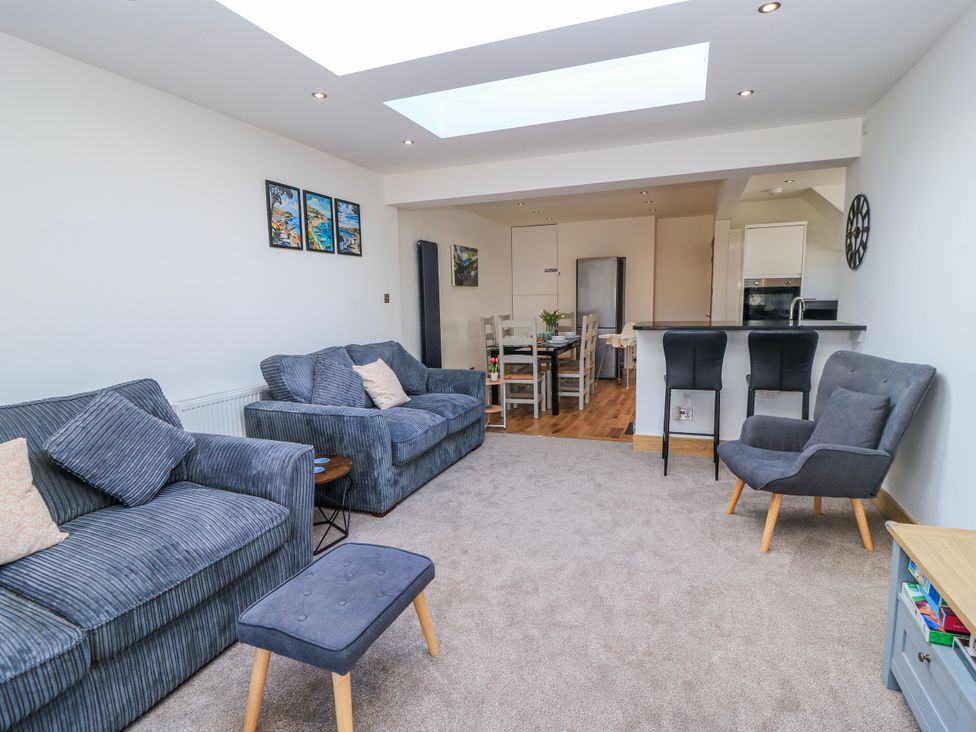A living room with sofas and a dining area at The Swanage Rail Lookout in Swanage