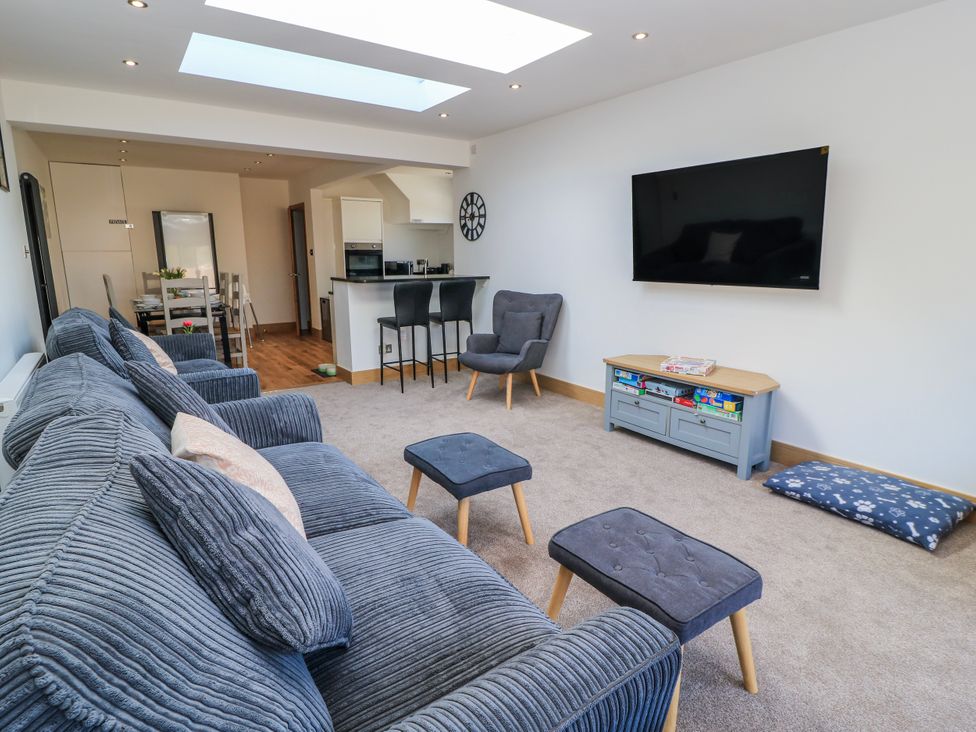 A living room with a television and sofa at The Swanage Rail Lookout in Swanage