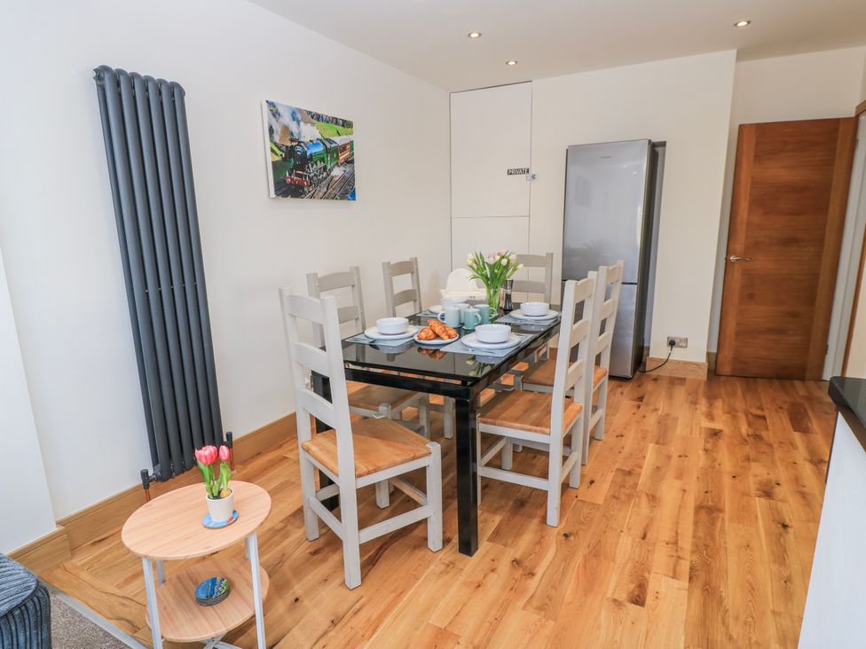 A dining room with a table set for a meal at The Swanage Rail Lookout in Swanage