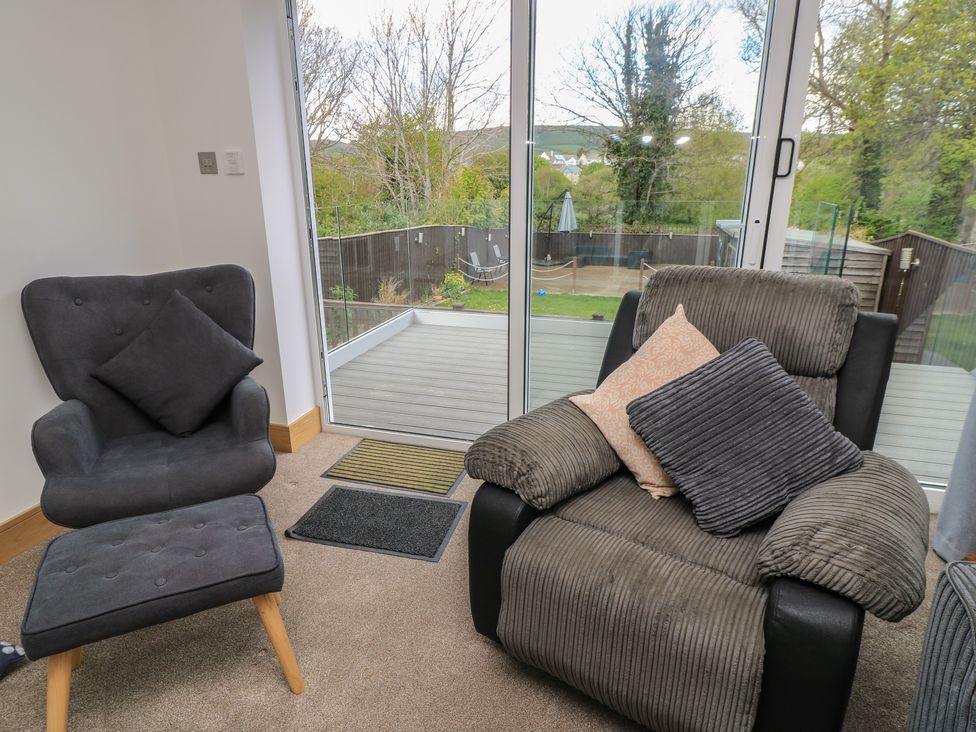 A living room with an armchair and footrest at The Swanage Rail Lookout in Swanage