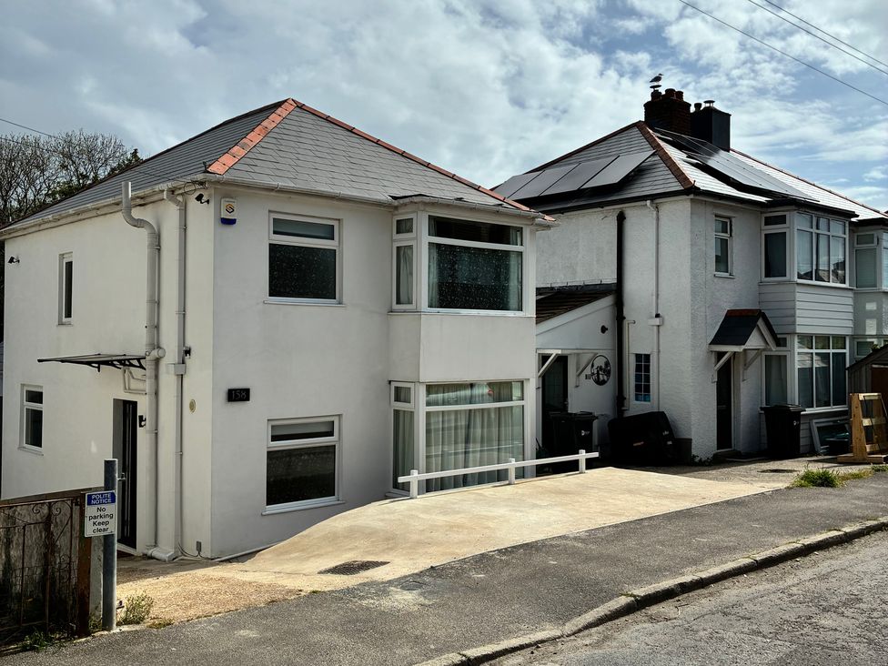 Two houses with driveways and solar panels at The Swanage Rail Lookout in Swanage