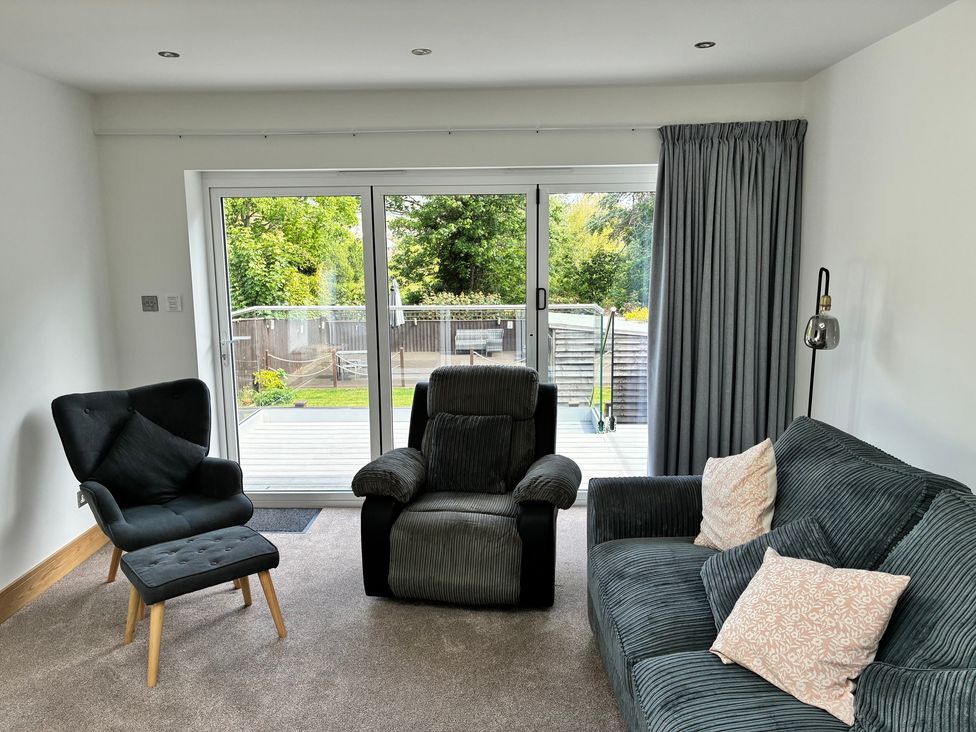 A living room with a sofa and armchair at The Swanage Rail Lookout in Swanage