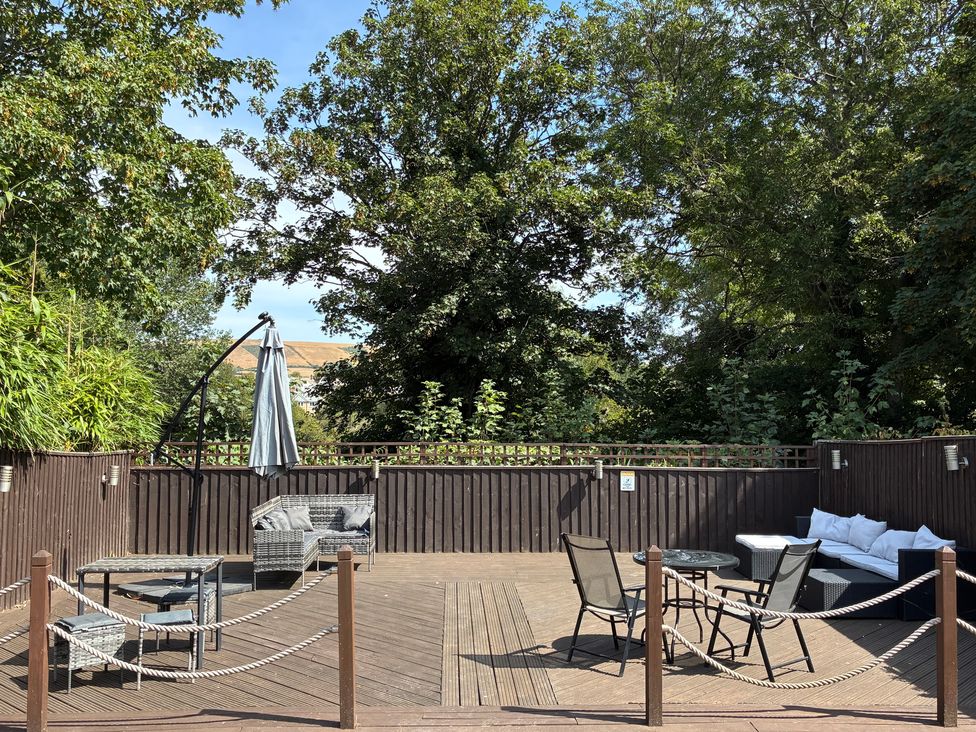 An outdoor area with seating and plants at The Swanage Rail Lookout in Swanage