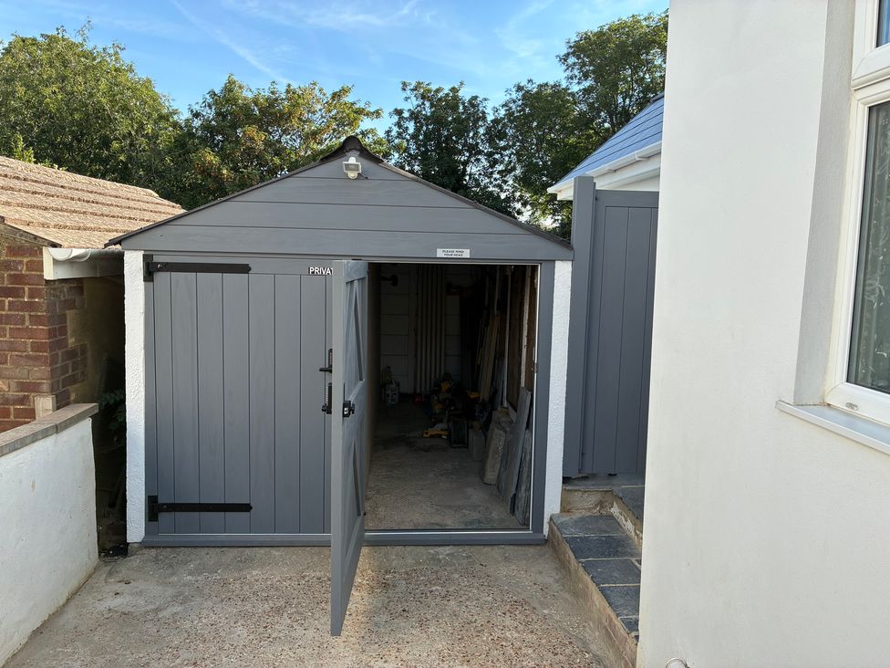 A shed with an open door and tools visible inside at The Swanage Rail Lookout in Swanage