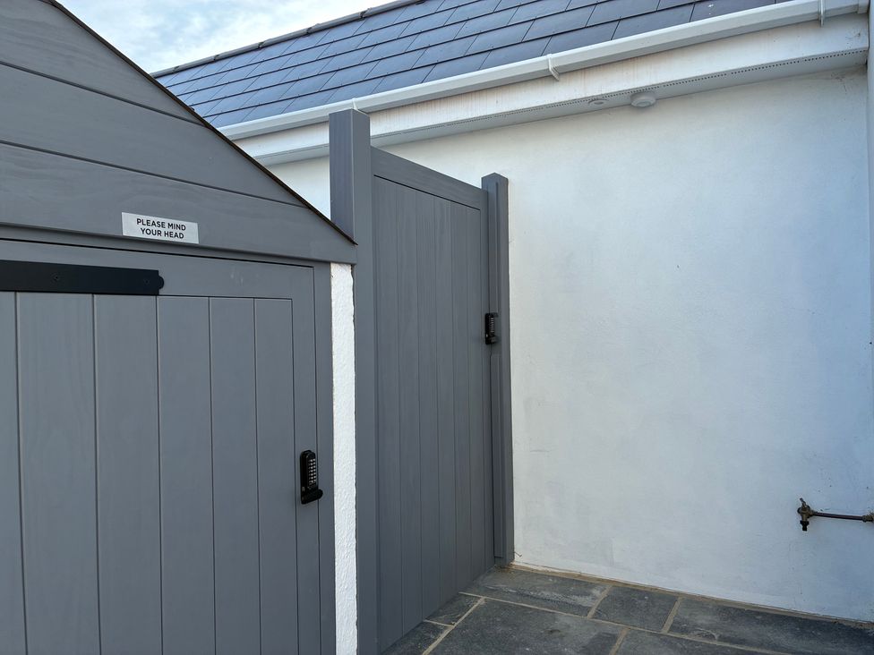 An outdoor area with a gray gate and wall at The Swanage Rail Lookout in Swanage