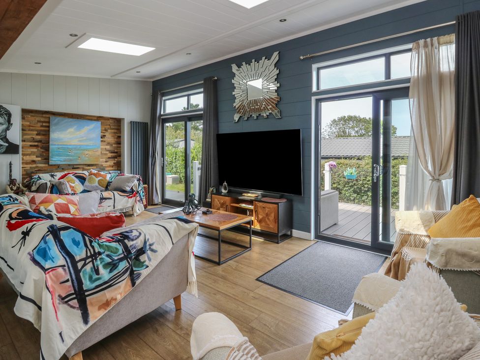 A living room with a sofa and coffee table at Coogee View in Maenygroes near New Quay