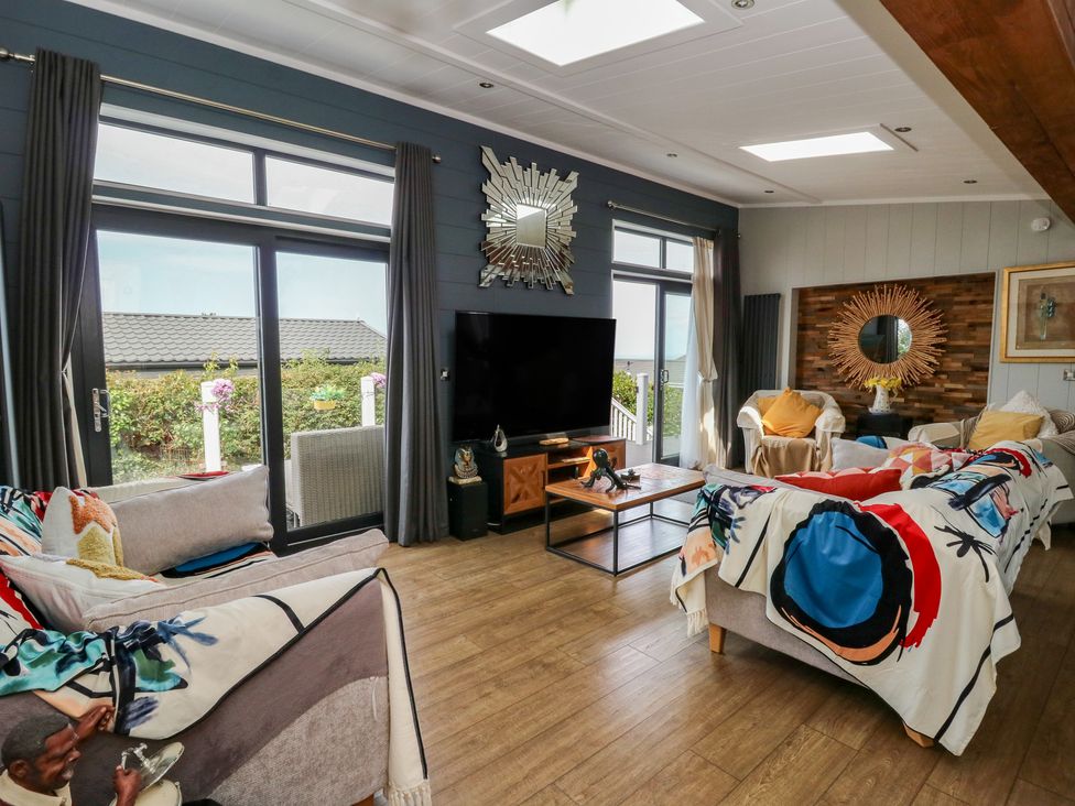 A living room with a television and coffee table at Coogee View near Maenygroes near New Quay