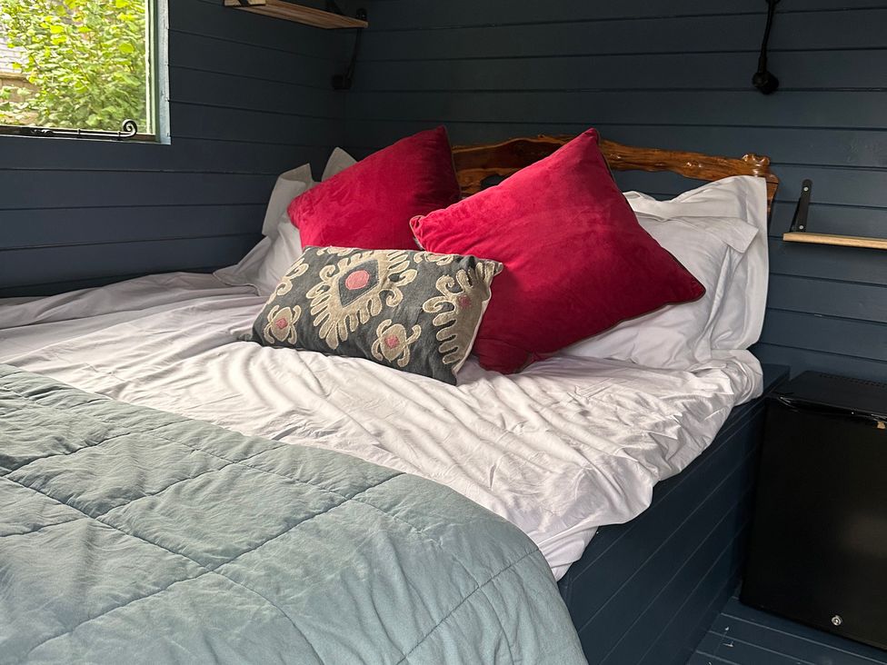 A bedroom with a bed and pillows at Acres Meadow in Maiden Newton