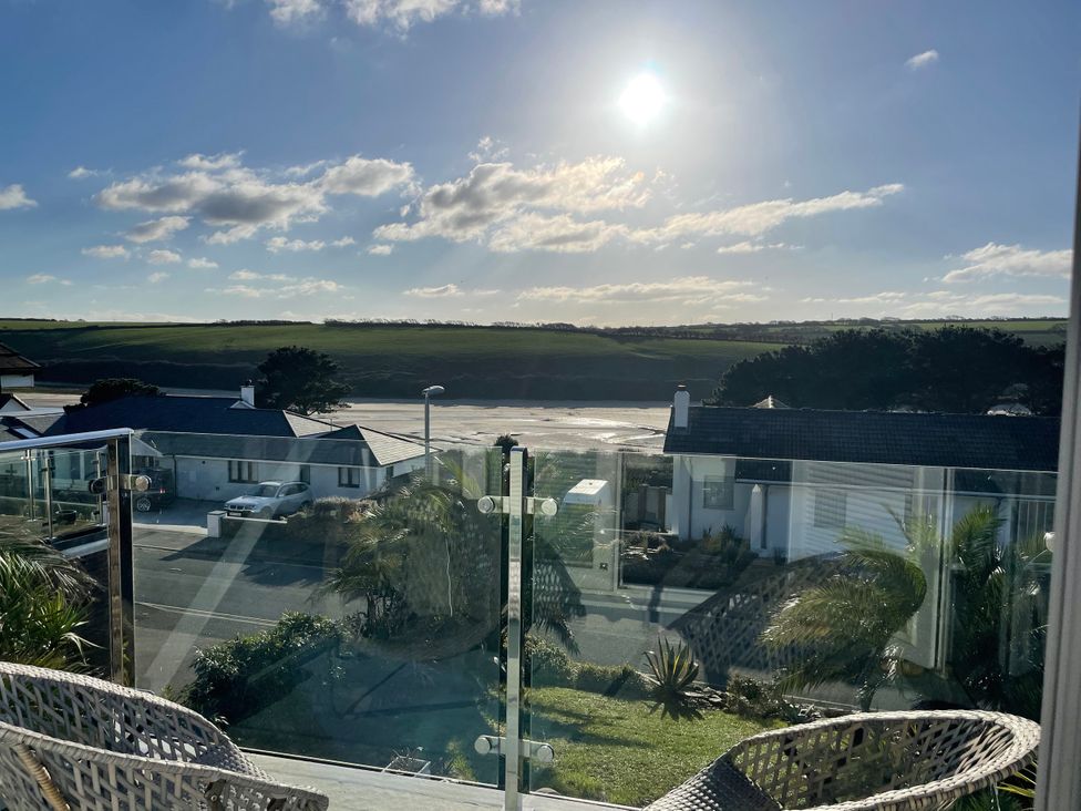 A view from a balcony overlooking houses and fields at Tidal View in Newquay