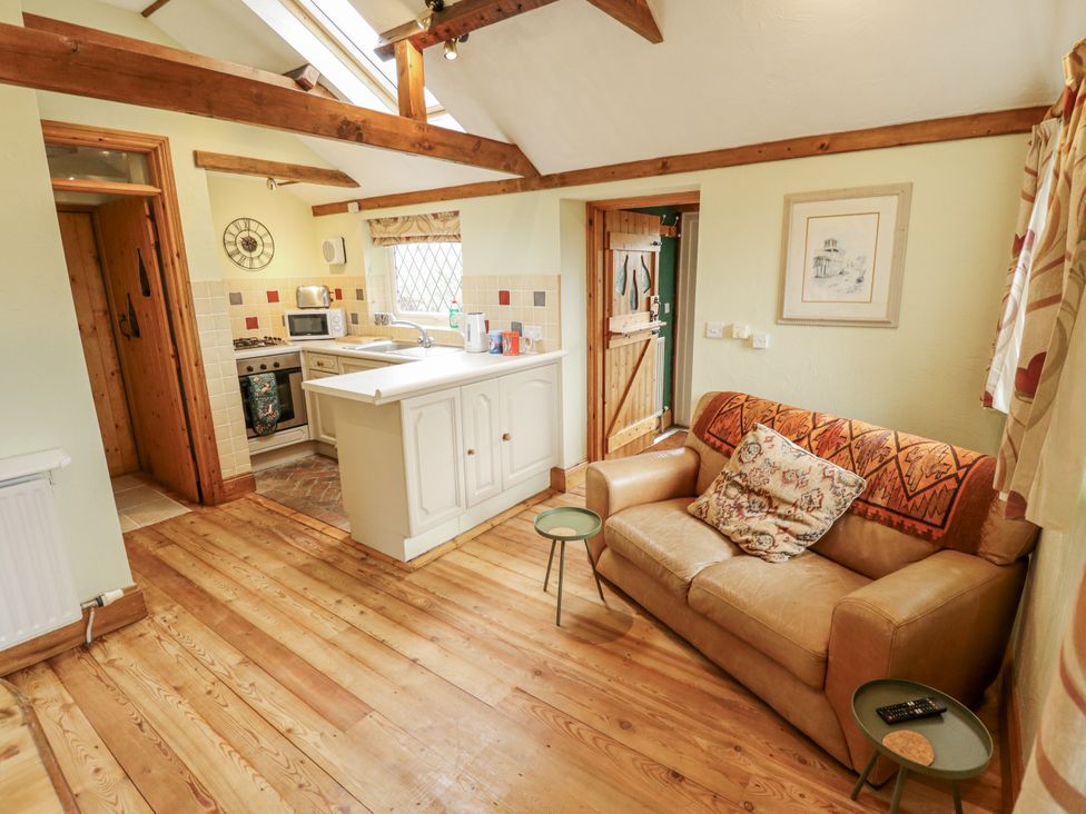 A kitchen with a sofa and appliances at Pendockie in Boston