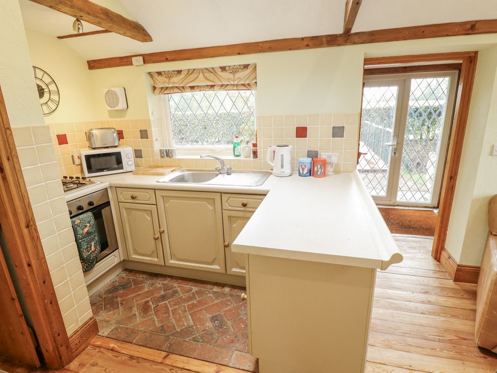 A kitchen with appliances and a door leading outside at Pendockie in Boston