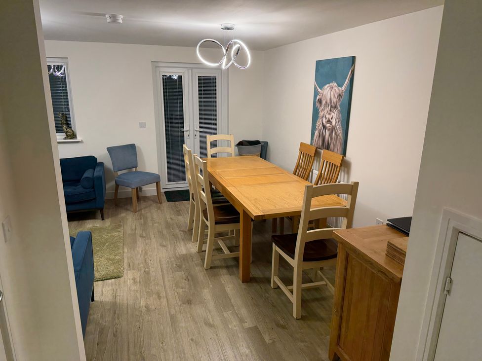 A dining room with a table and chairs at 37 Devana Gardens Chester