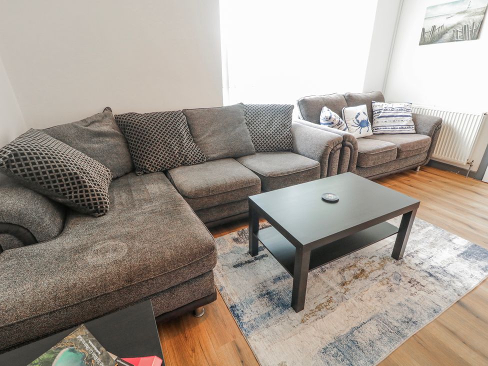 A living room with a gray sofa and a coffee table at The Island's View in Gortahork, County Donegal