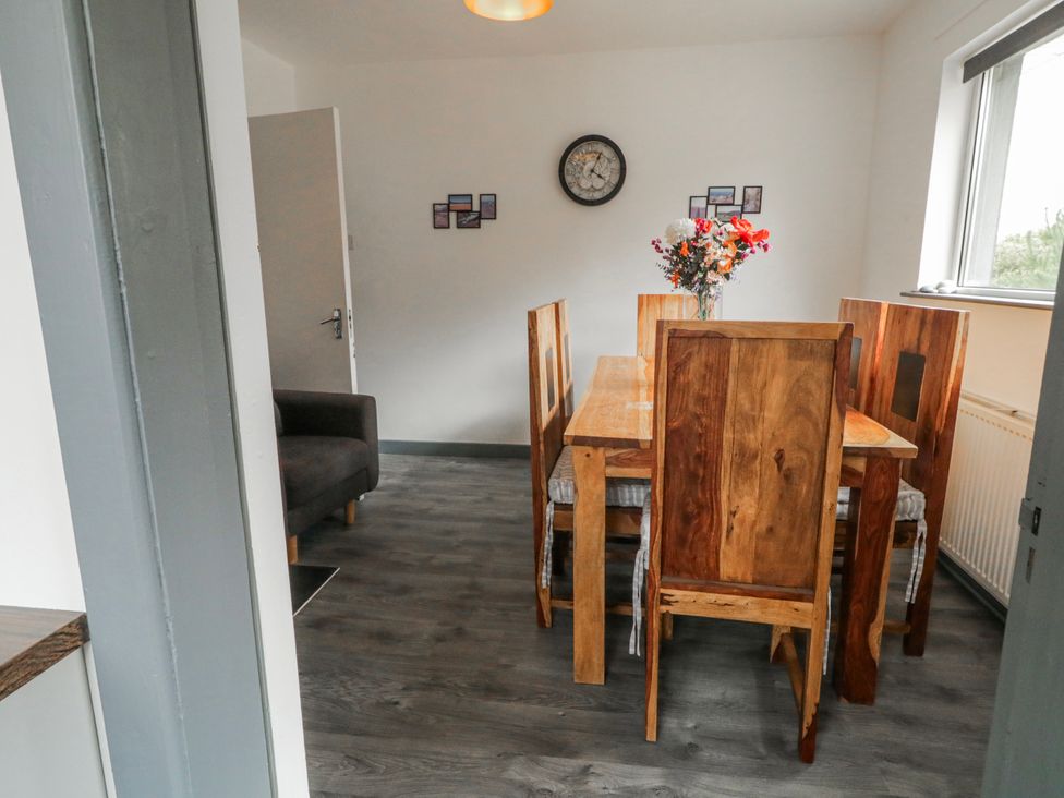 A dining room with a wooden table and chairs at The Island's View in Gortahork, County Donegal