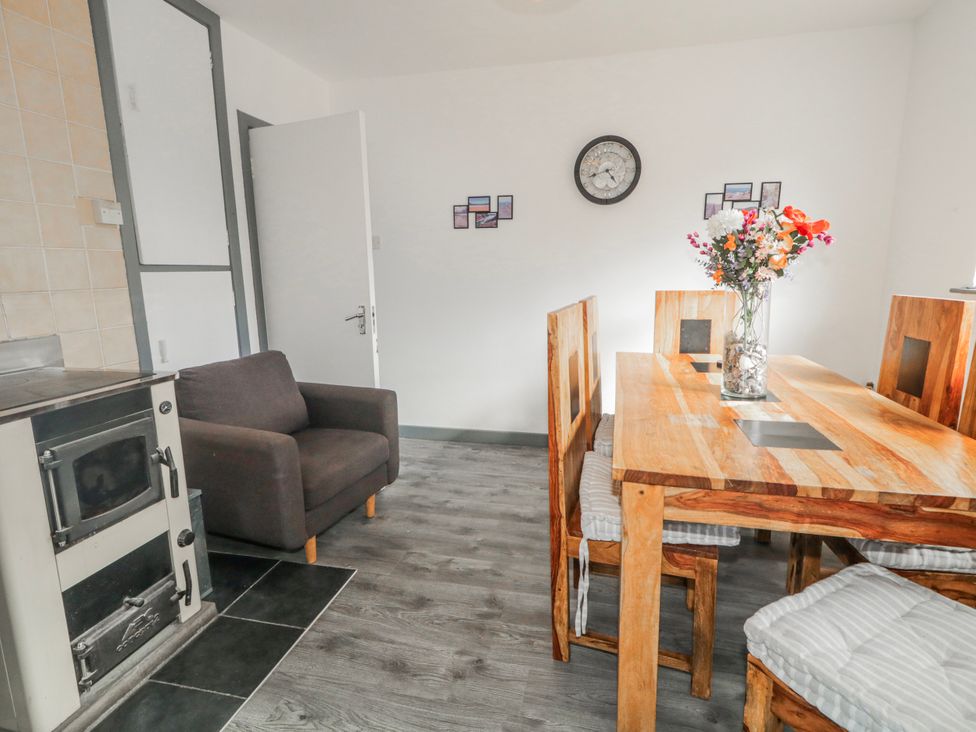 A dining room with a wooden table and chairs at The Island's View in Gortahork, County Donegal