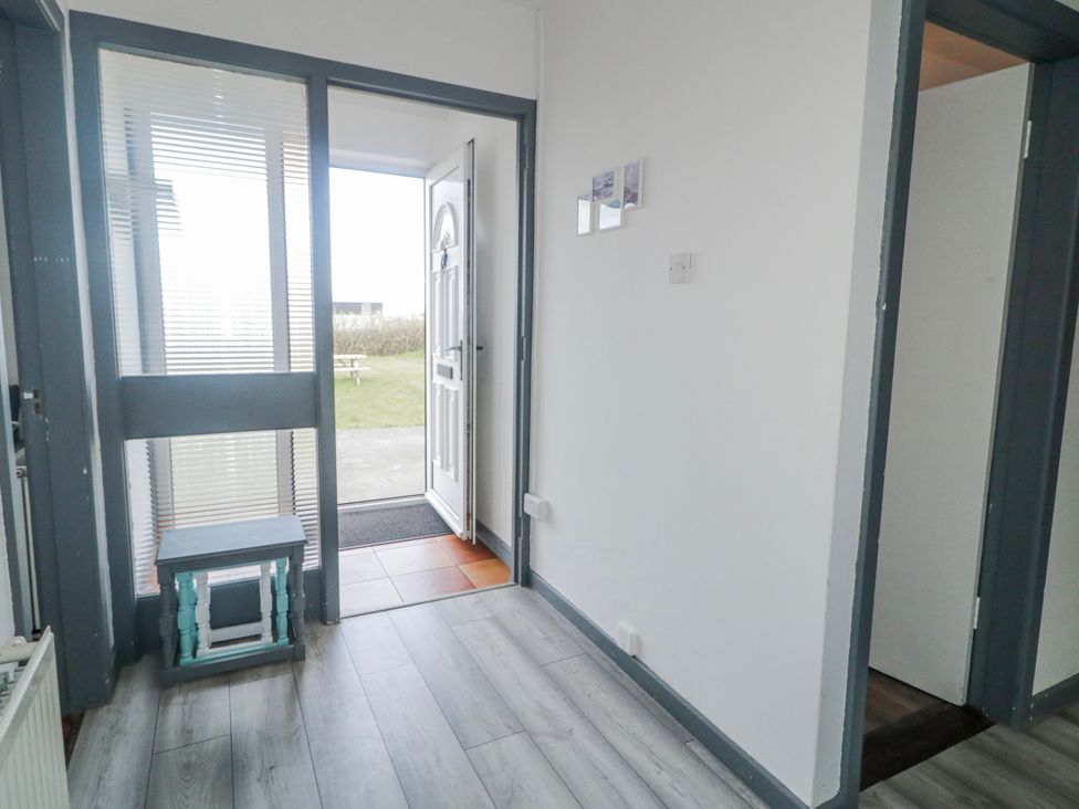 A hallway with a door and a bench at The Island's View in Gortahork, County Donegal