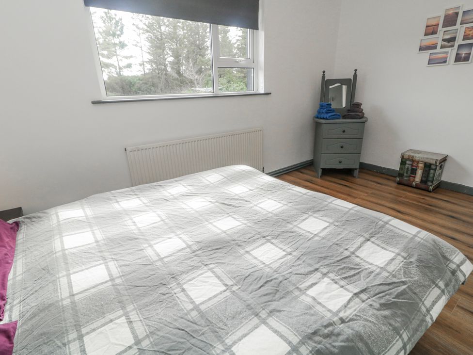 A bedroom with a bed and a mirror at The Island's View in Gortahork, County Donegal