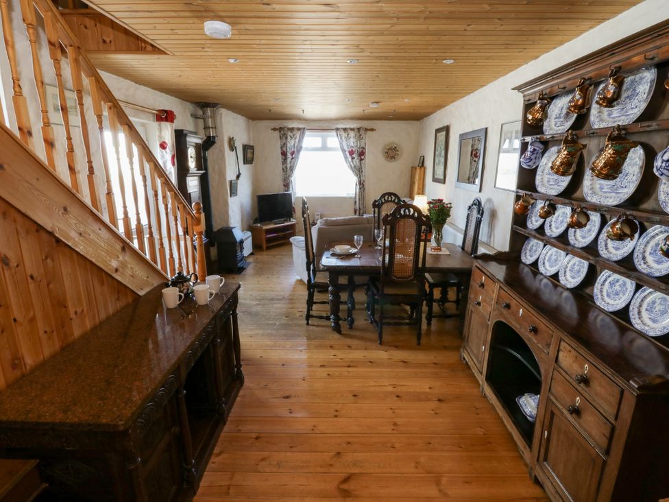 A living room with a table and chairs beside a sofa at Harbour High Annex in Fishguard