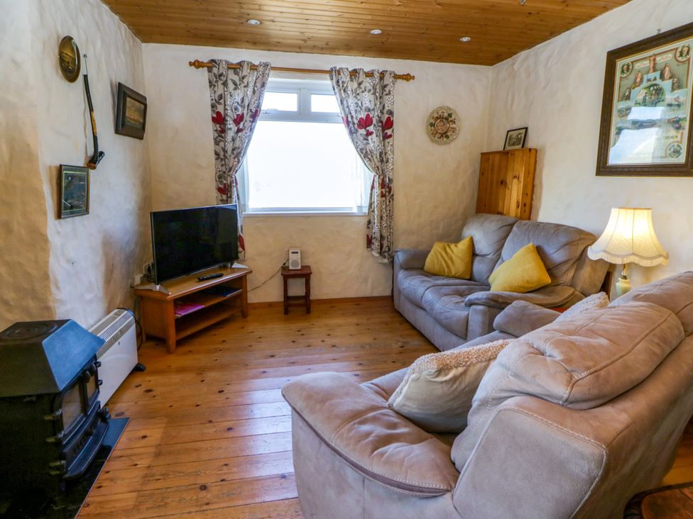 A living room with a television and sofa at Harbour High Annex in Fishguard