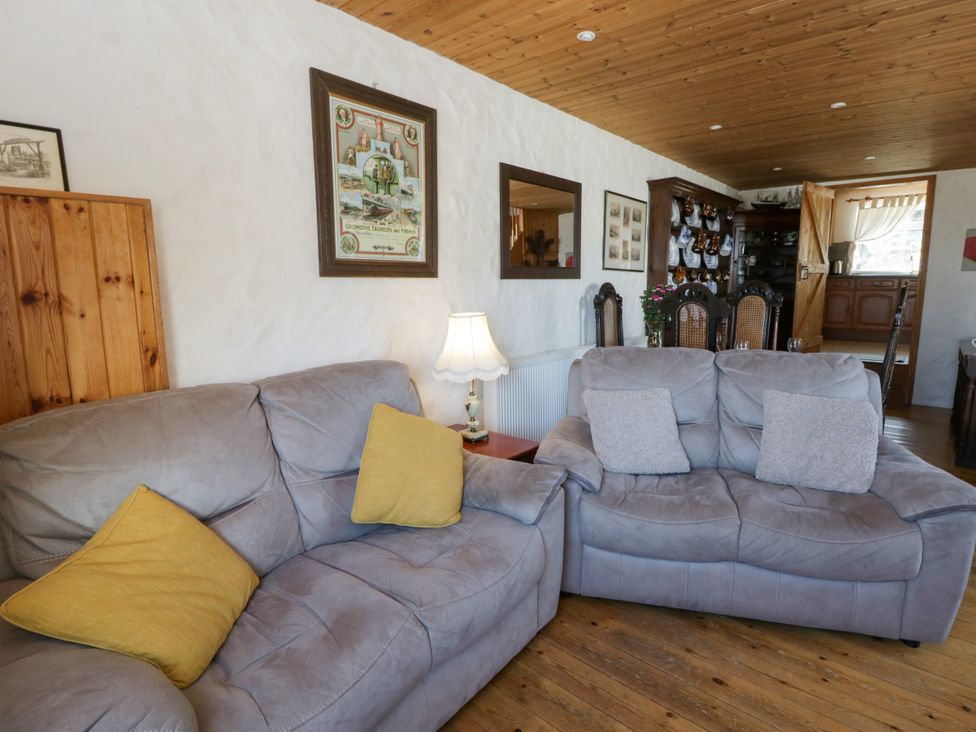 A living room with sofas and a lamp at Harbour High Annex in Fishguard