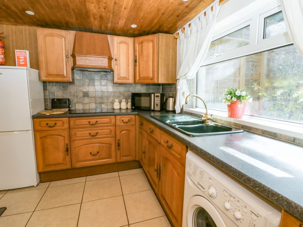 A kitchen with cabinets, sink, and appliances at Harbour High Annex in Fishguard
