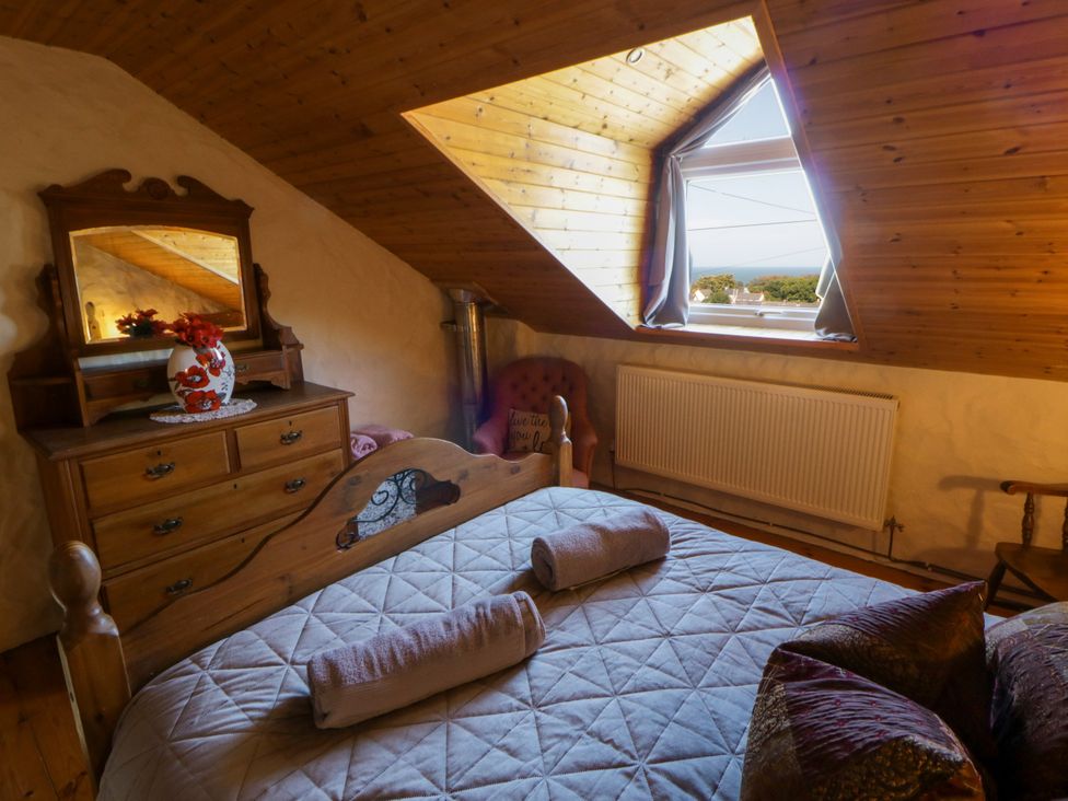 A bedroom with a bed and dresser at Harbour High Annex in Fishguard