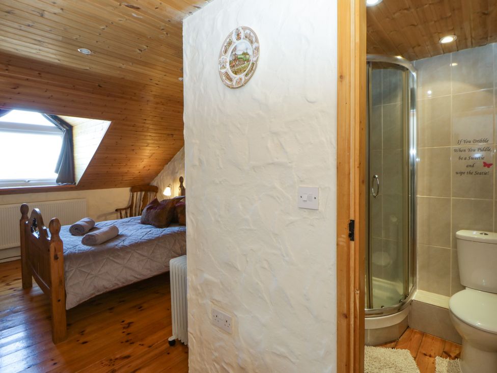 A bedroom with a bed and shower area at Harbour High Annex in Fishguard