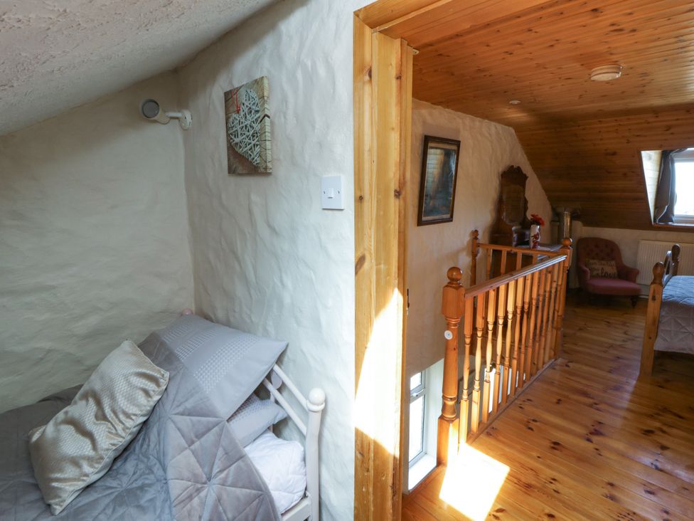 A bedroom with a bed and railing at Harbour High Annex in Fishguard