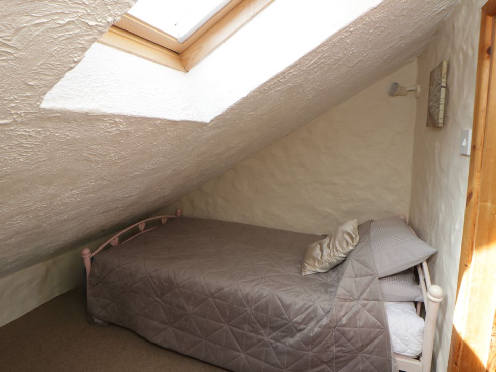 A bedroom with a bed and skylight at Harbour High Annex Fishguard