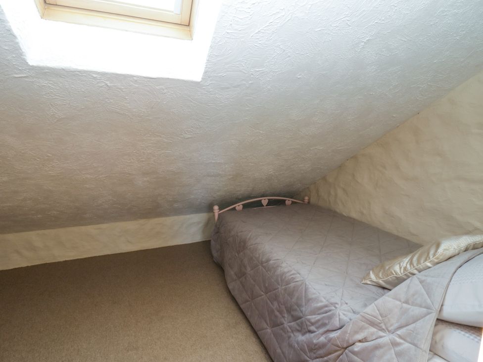 A bedroom with a bed and window at Harbour High Annex in Fishguard