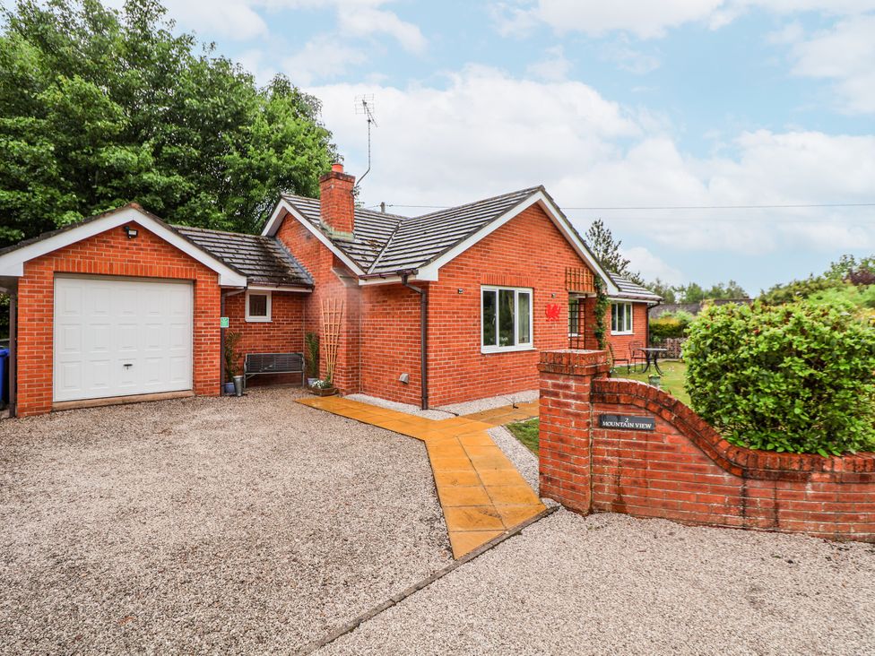 A house with a garage and pathway at 2 Mountain View in Chirk