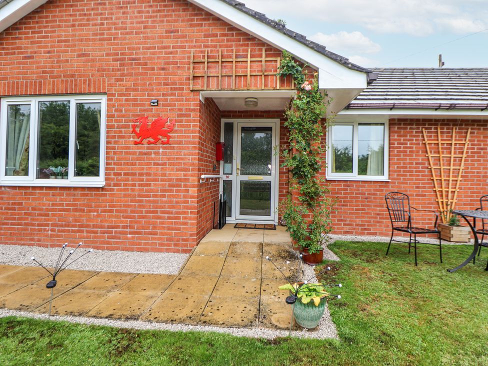 A house exterior with a front door and seating area at 2 Mountain View Chirk