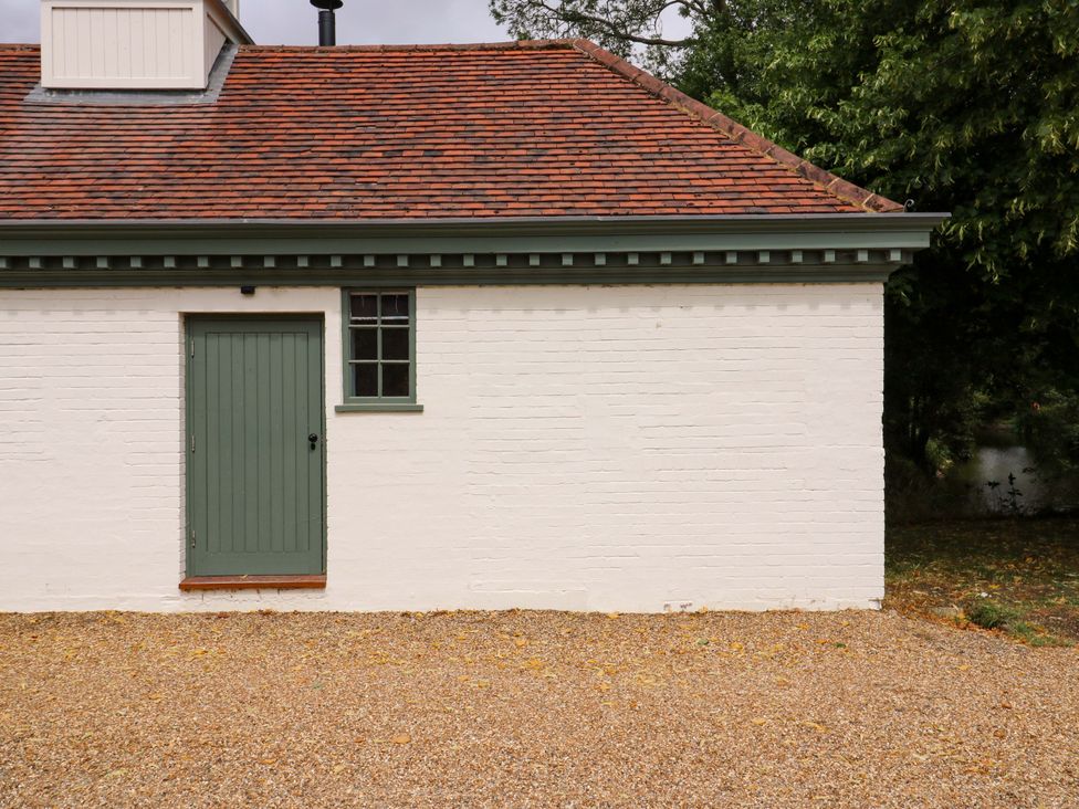 A exterior view of a building featuring a green door and window at Clock Tower in Stowmarket
