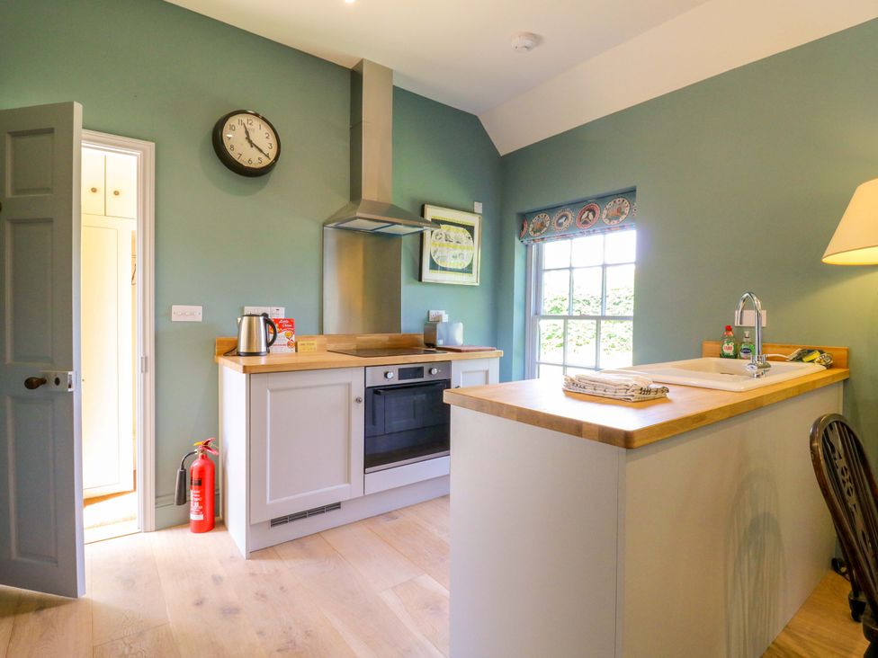 A kitchen with appliances and a window at Clock Tower in Stowmarket