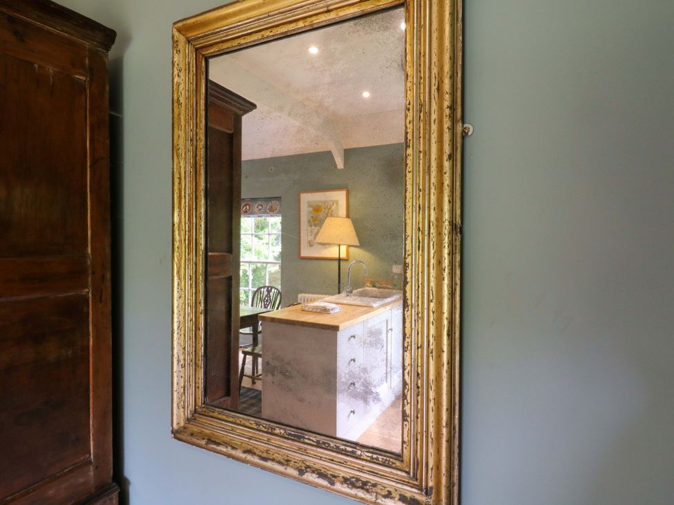 A mirror reflecting a kitchen area at Clock Tower in Stowmarket