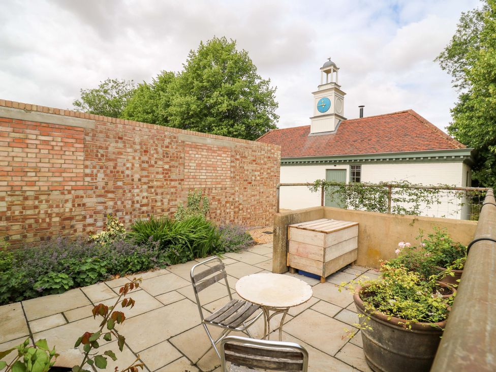 A garden with a table and chair at Clock Tower in Stowmarket