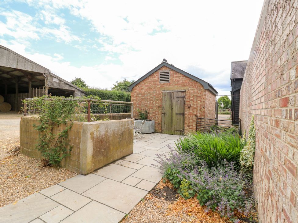 An outdoor area with a path and a brick building at Clock Tower in Stowmarket