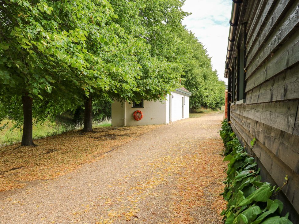 A pathway with trees and a building at Clock Tower in Stowmarket