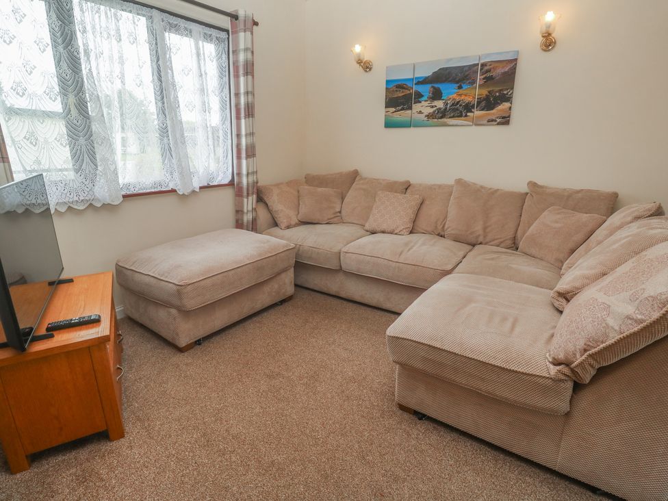 A living room with a couch and television at 14 Bosvigo Ruan Major near Penhale