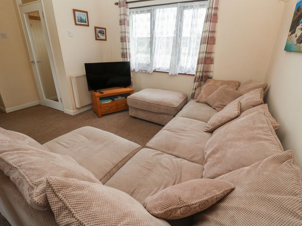 A living room with a sofa and television at 14 Bosvigo Ruan Major near Penhale